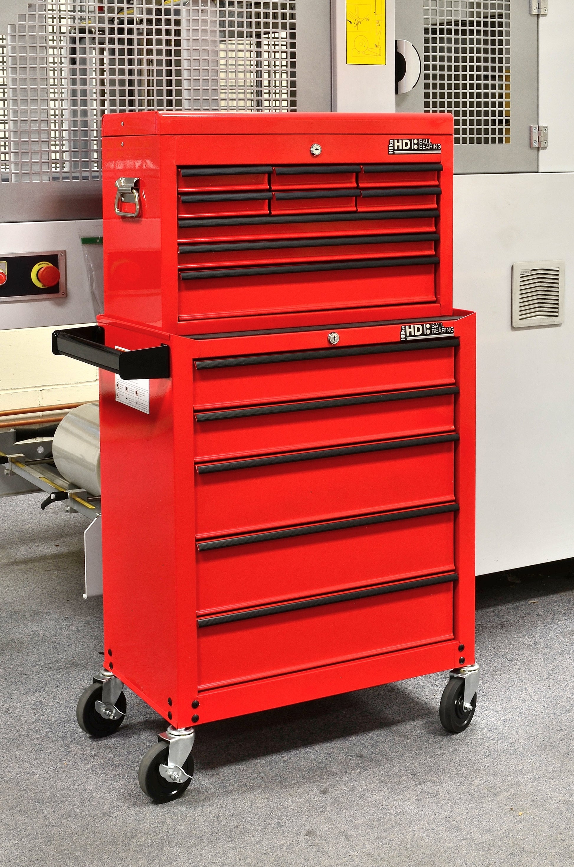 Red tool chest with multiple drawers in a workshop setting