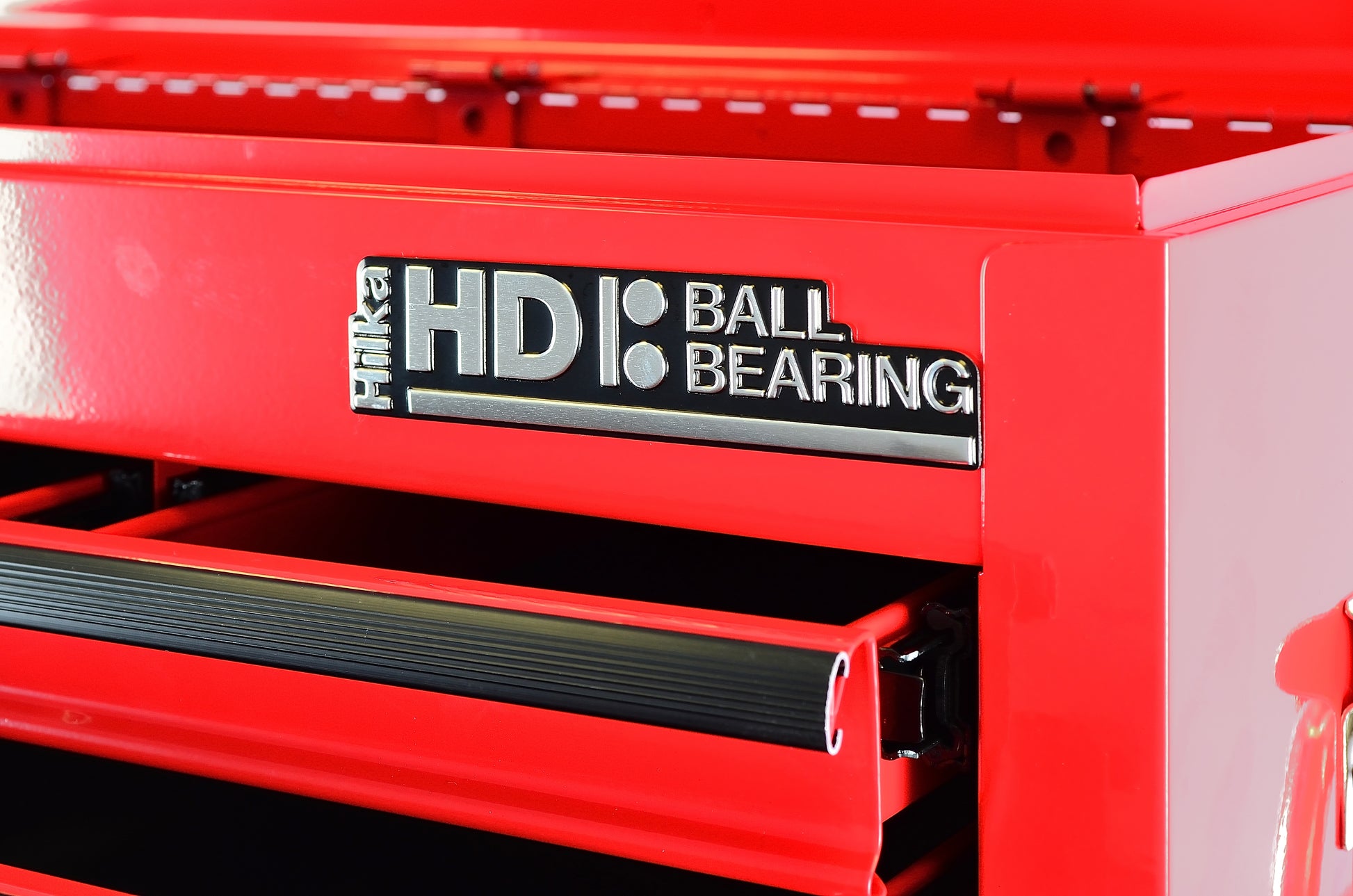 Red tool chest with 'HDL Ball Bearing' label on a black background