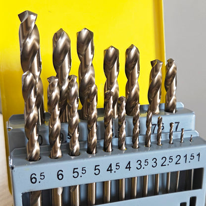 Set of drill bits in a holder with a yellow background