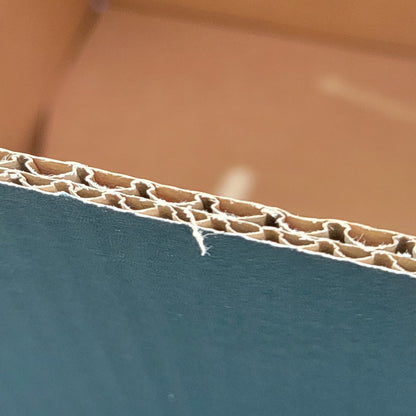 Close-up of a corrugated cardboard edge with a blurred background