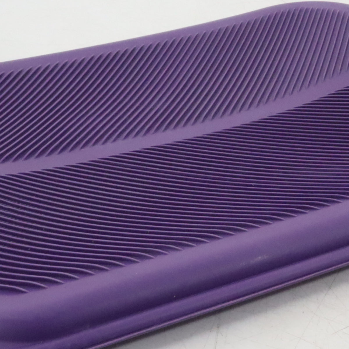 Close-up of a purple textured object on a light gray background