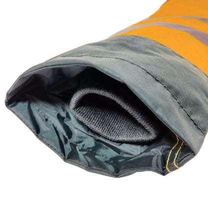 Close-up of a rolled-up sleeping bag with gray interior and yellow exterior.